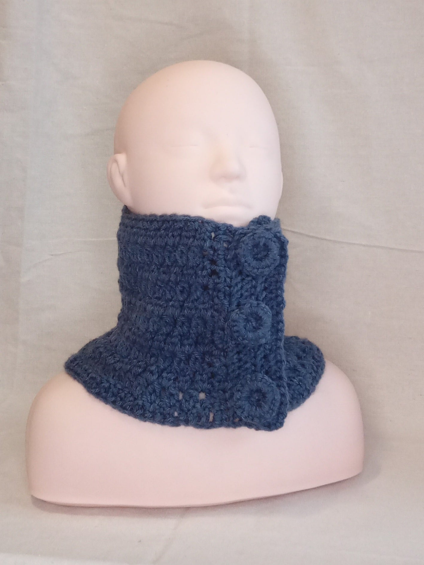 "Denim" Blue knitted cowl on a mannequin head against a neutral background